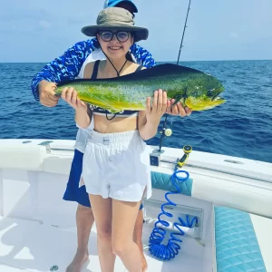 Young guest proudly holding dorado on fishing charter in Fujairah UAE