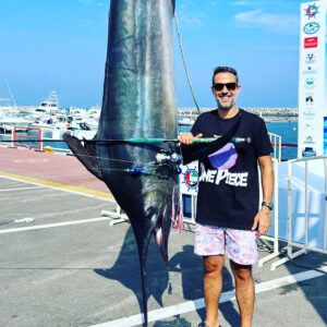 Grandslam charters guest next to huge billfish after successful fishing charter in Fujairah UAE
