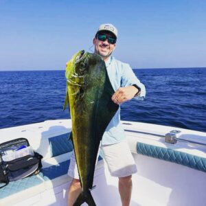 Guest holding huge Dorado during deep sea fishing charter in Fujairah UAE