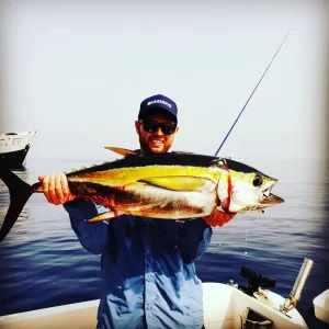 Grandslam Charters captain with fresh yellowfin tuna aboard a fishing charter in Fujairah UAE