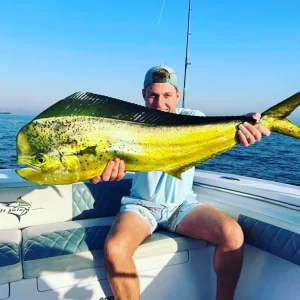 Guest holding large dorado caught on fishing charter in Fujairah UAE