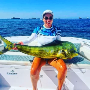 Proud guest holding dorado catch on a fishing charter in Fujairah UAE