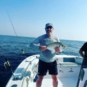 Grandslam guest showing off trevally caught on fishing charter in Fujairah UAE