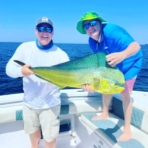 Two guests holding a dorado on deep sea charter in Fujairah UAE