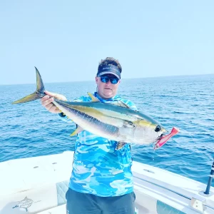 Captain Dante with a yellowfin tuna on fishing charter in Fujairah UAE