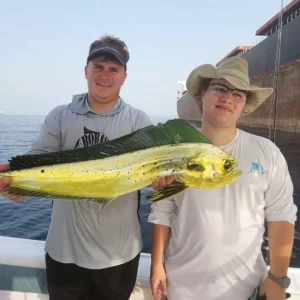 Grandslam charters captain Dante holding a dorado with a guest on a fishing charter in Fujairah UAE