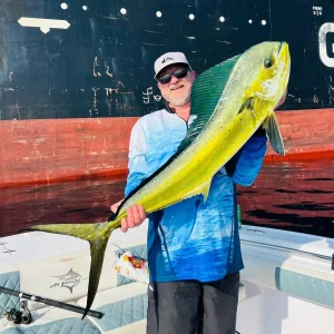 Proud guest holding huge dorado on a deep sea fishing charter in Fujairah UAE