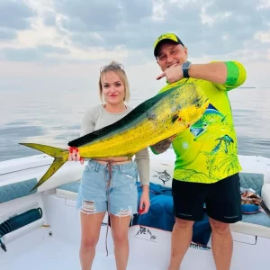 a couple both holding a dorado they caught on fishing charter in Fujairah UAE