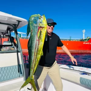 Guest holding a large bleeding dorado on a fishing charter in Fujairah UAE