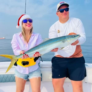 Captain Dante and guest both holding a rainbow fish caught on fishing charter in Fujairah UAE