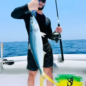 Guest with rainbow fish catch on successful fishing charter in Fujairah UAE
