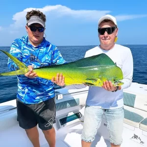 Grandslam captain Dante and a guest both holding a dorado while on a fishing charter in Fujairah UAE