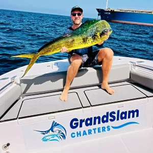 Guest Holding a dorado caught on a fishing charter in Fujairah UAE