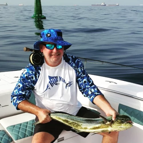 Happy Grandslam captain with catch on fishing charter in Fujairah UAE