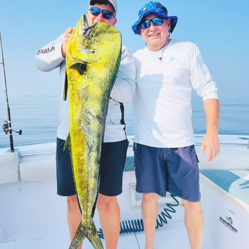 Two Grandslam captain showing off large dorado catch during fishing charter in Fujairah UAE