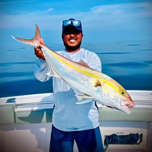 Smiling Grandslam captain with catch on deep sea fishing charter in Fujairah UAE